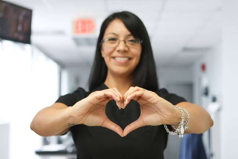 Clinic Worker holding a hand sign of a heart