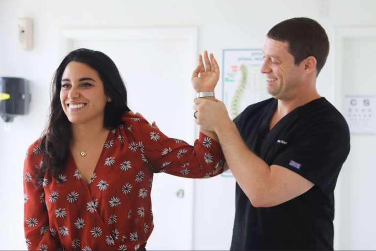 Clinic worker examining patient's wrist